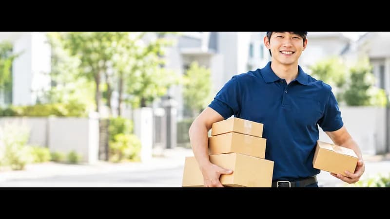 JP Vapes delivery driver carrying parcels